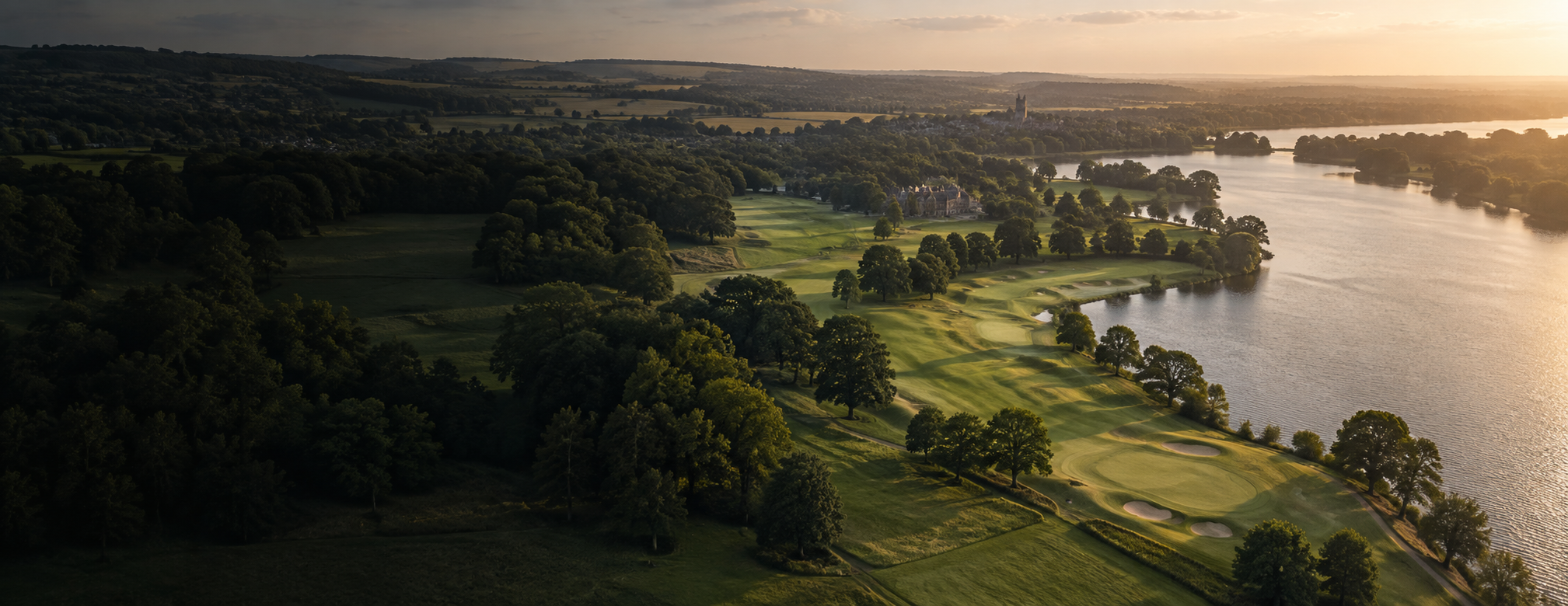 A golf course and lake within a wide outdoor landscape
